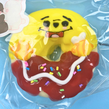 Smiling Donut Squishy Toy with Frosting and Sprinkles